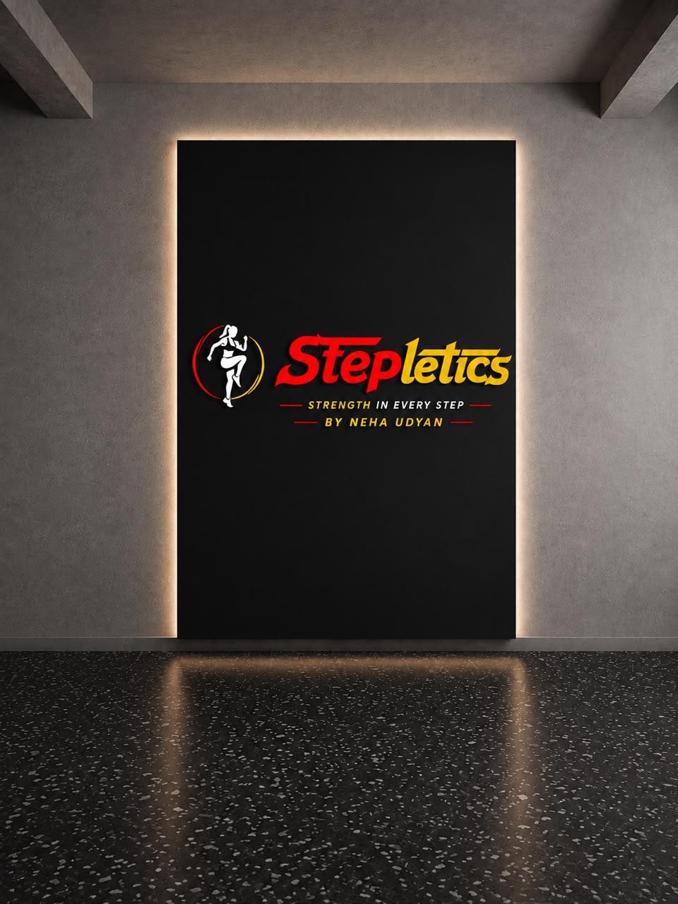 The backlit Stepletics logo panel mounted on the studio wall